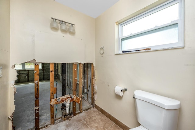 11465 7th St E, Treasure Island, FL 33706 - bathroom featuring toilet, baseboards, and tile patterned flooring