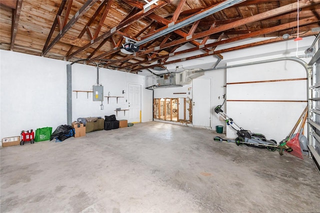 11465 7th St E, Treasure Island, FL 33706 - garage featuring electric panel and a garage door opener