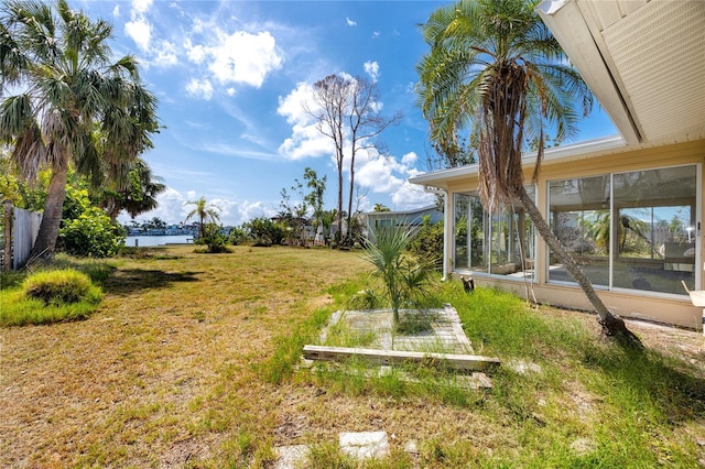 11465 7th St E, Treasure Island, FL 33706 - view of green lawn with a sunroom