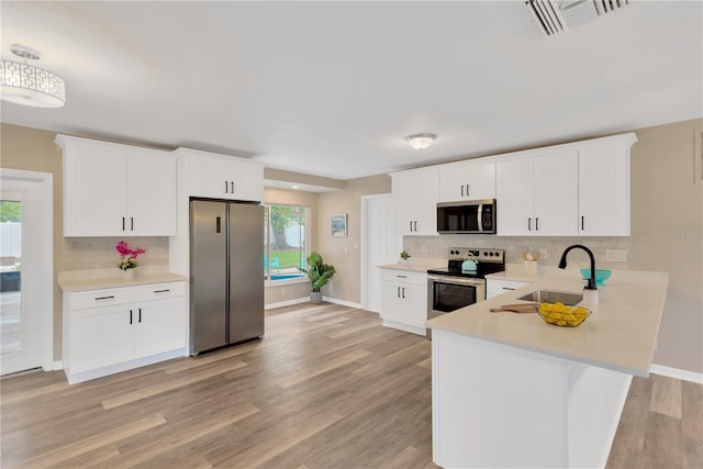 704 Childers Loop, Brandon, FL 33511 - kitchen featuring stainless steel appliances, a sink, light countertops, and decorative backsplash