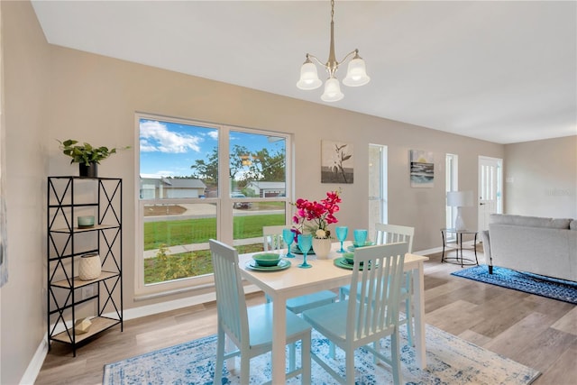 704 Childers Loop, Brandon, FL 33511 - dining space featuring baseboards, light wood-style flooring, and a chandelier