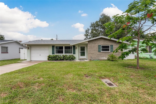 2020 Douglas Ave, Dunedin, FL 34698 - ranch-style home with concrete driveway, a garage, a front yard, and stucco siding