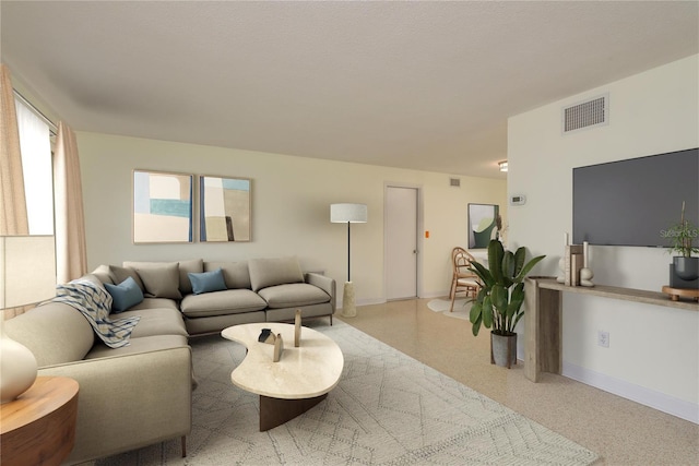 2020 Douglas Ave, Dunedin, FL 34698 - living room with baseboards and speckle patterned floor