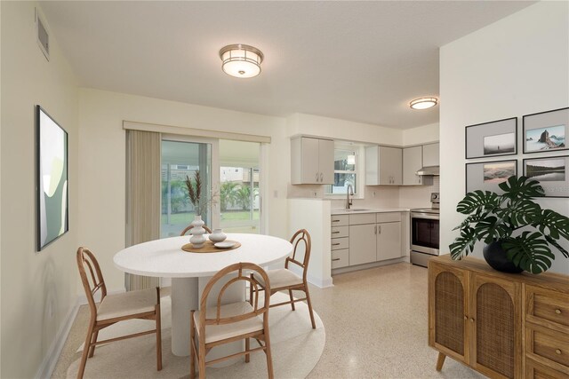 2020 Douglas Ave, Dunedin, FL 34698 - dining space with baseboards and dark speckled floor