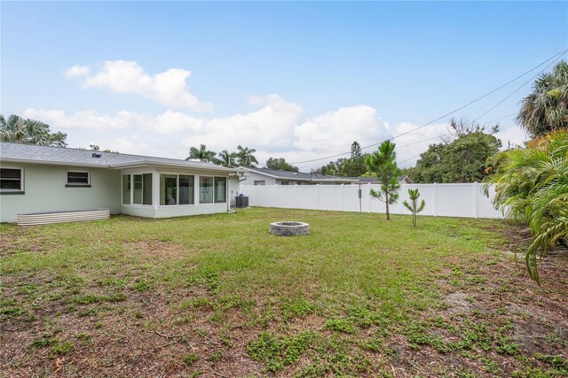 2020 Douglas Ave, Dunedin, FL 34698 - view of yard featuring an outdoor fire pit, a sunroom, and cooling unit