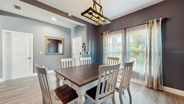 8111 Brickleton Woods Ave, Gibsonton, FL 33534 - dining space featuring light wood-type flooring, baseboards, and a chandelier