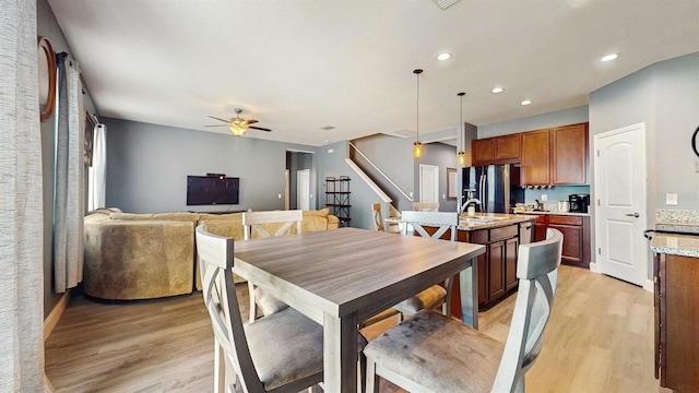8111 Brickleton Woods Ave, Gibsonton, FL 33534 - dining room featuring light wood-style flooring, stairs, ceiling fan, and recessed lighting