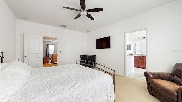 8111 Brickleton Woods Ave, Gibsonton, FL 33534 - bedroom with light colored carpet, ceiling fan, and connected bathroom