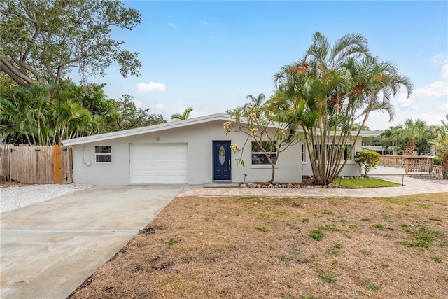 12 Bayou Ln, Palm Harbor, FL 34683 - ranch-style home with driveway, a garage, and stucco siding