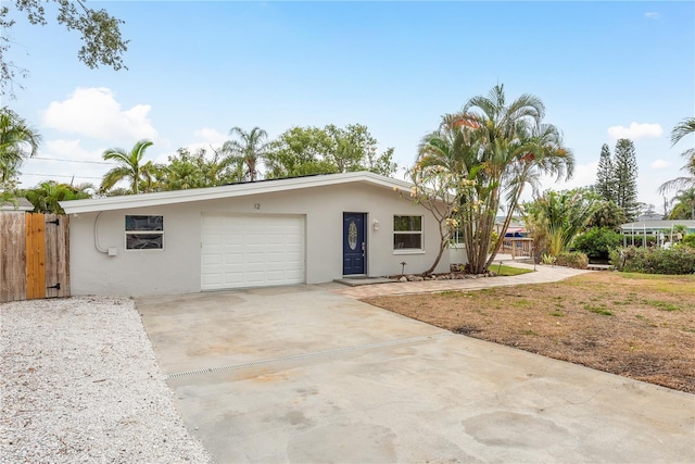 12 Bayou Ln, Palm Harbor, FL 34683 - single story home featuring an attached garage, stucco siding, and driveway