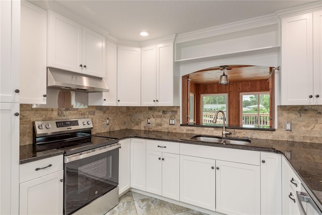 12 Bayou Ln, Palm Harbor, FL 34683 - kitchen featuring electric stove, under cabinet range hood, arched walkways, white cabinets, and recessed lighting