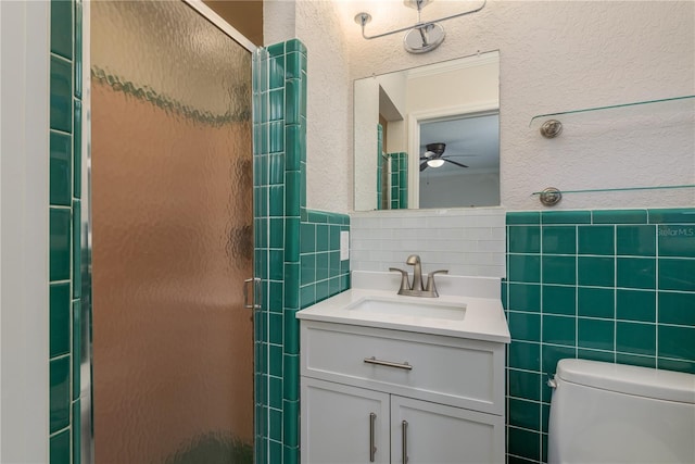 12 Bayou Ln, Palm Harbor, FL 34683 - bathroom featuring tile walls, vanity, a shower stall, ceiling fan, and a textured wall