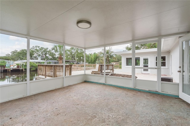 12 Bayou Ln, Palm Harbor, FL 34683 - unfurnished sunroom featuring a water view