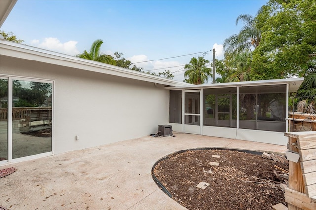 12 Bayou Ln, Palm Harbor, FL 34683 - view of patio / terrace featuring a sunroom