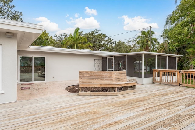 12 Bayou Ln, Palm Harbor, FL 34683 - wooden deck featuring a sunroom