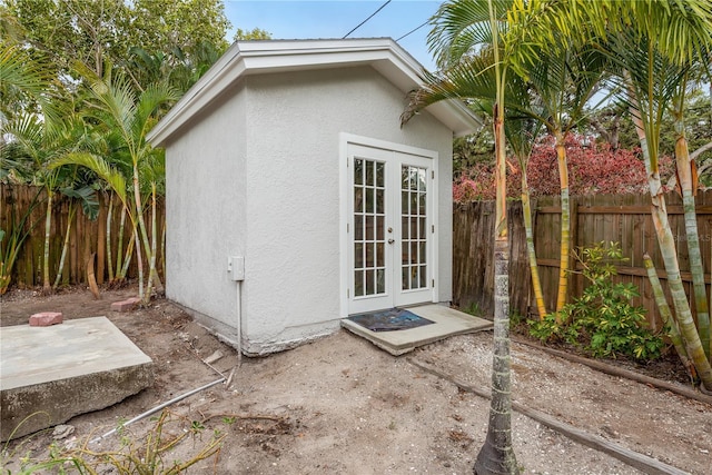 12 Bayou Ln, Palm Harbor, FL 34683 - view of outdoor structure featuring french doors and a fenced backyard