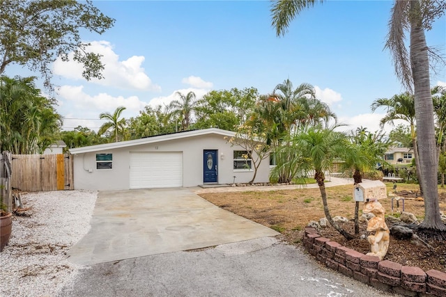 12 Bayou Ln, Palm Harbor, FL 34683 - ranch-style house with concrete driveway, an attached garage, and stucco siding