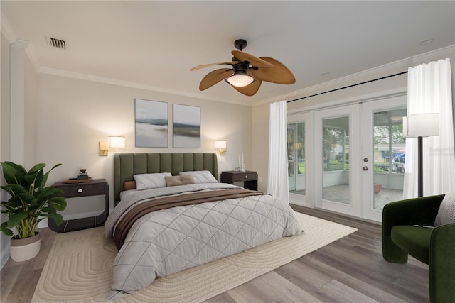 12 Bayou Ln, Palm Harbor, FL 34683 - bedroom featuring french doors, access to exterior, wood finished floors, ornamental molding, and ceiling fan