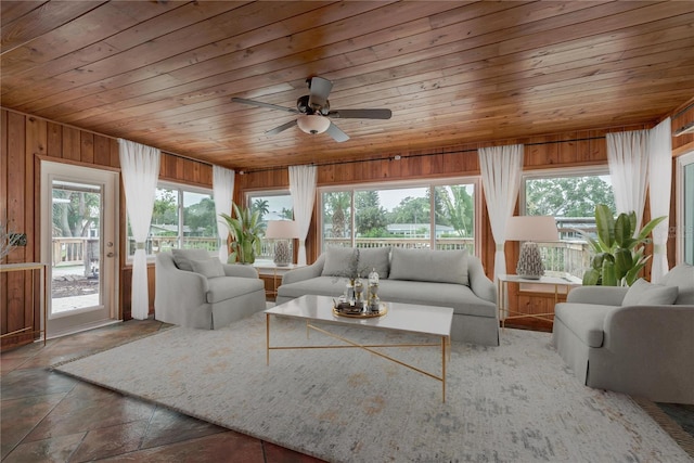12 Bayou Ln, Palm Harbor, FL 34683 - living area with wood ceiling, wood walls, and a ceiling fan