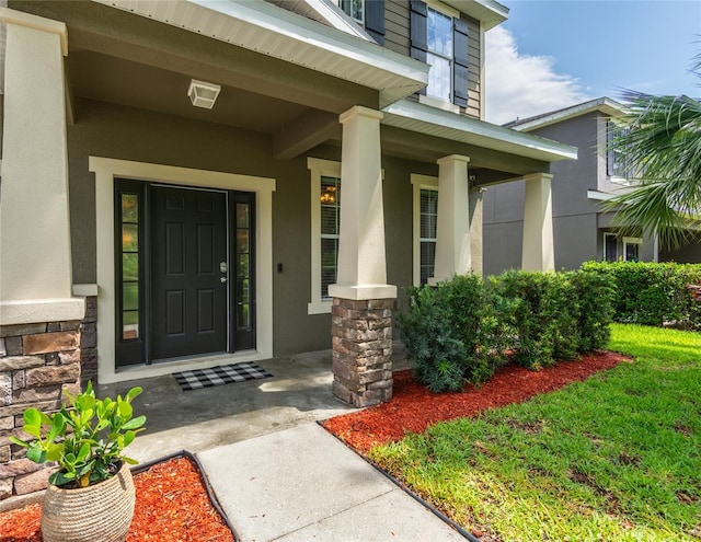 12208 Mcmullen Loop, Riverview, FL 33569 - entrance to property featuring covered porch, stone siding, and stucco siding