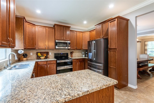 12208 Mcmullen Loop, Riverview, FL 33569 - kitchen with appliances with stainless steel finishes, a sink, crown molding, light stone countertops, and backsplash