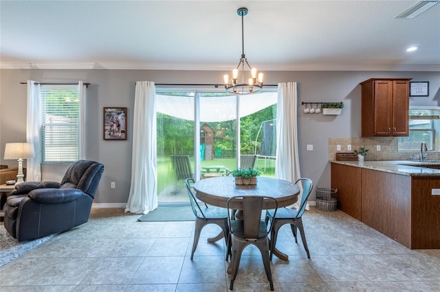 12208 Mcmullen Loop, Riverview, FL 33569 - dining space featuring ornamental molding, a chandelier, and baseboards