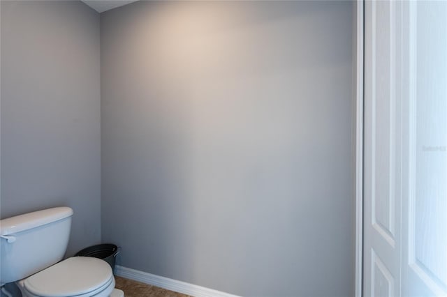 12208 Mcmullen Loop, Riverview, FL 33569 - bathroom with toilet, baseboards, and tile patterned flooring