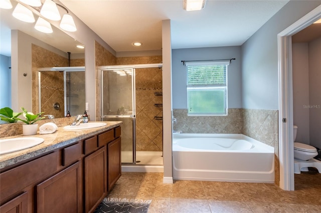 12208 Mcmullen Loop, Riverview, FL 33569 - bathroom featuring toilet, a bath, a shower stall, double vanity, and tile patterned floors