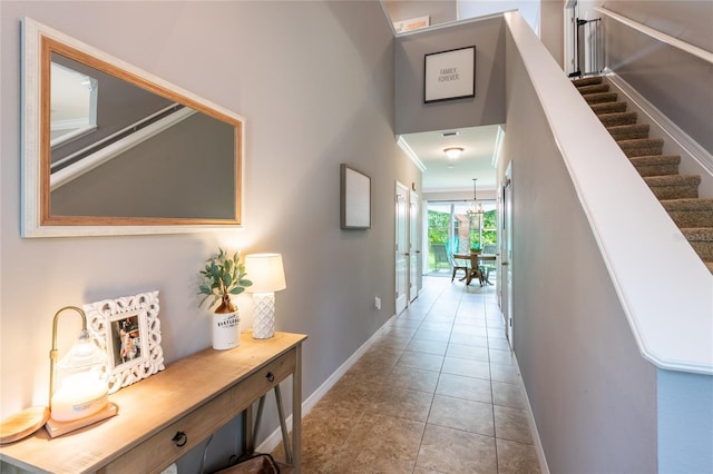 12208 Mcmullen Loop, Riverview, FL 33569 - hall featuring baseboards, stairs, tile patterned floors, a chandelier, and crown molding