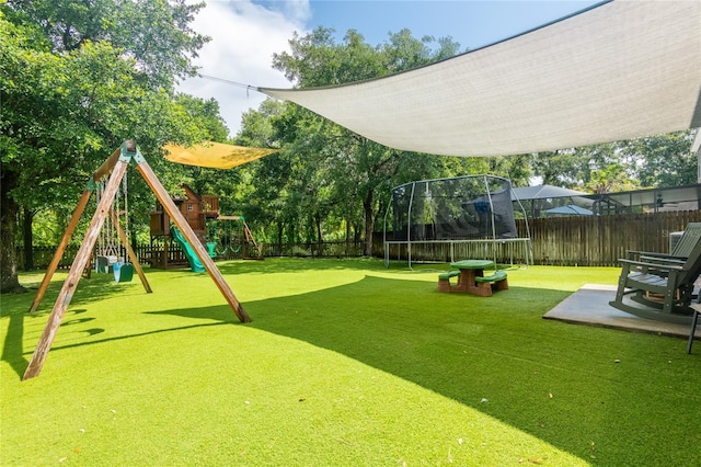 12208 Mcmullen Loop, Riverview, FL 33569 - view of yard featuring a trampoline, a playground, and a patio area