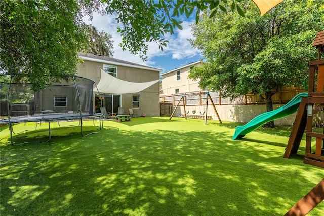 12208 Mcmullen Loop, Riverview, FL 33569 - view of yard with a trampoline and a playground