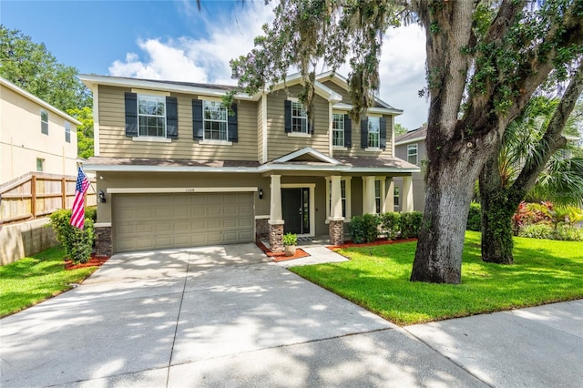 12208 Mcmullen Loop, Riverview, FL 33569 - view of front of house featuring an attached garage, concrete driveway, stone siding, and stucco siding
