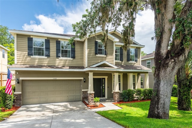 12208 Mcmullen Loop, Riverview, FL 33569 - craftsman house featuring driveway, an attached garage, stone siding, a front yard, and roof with shingles