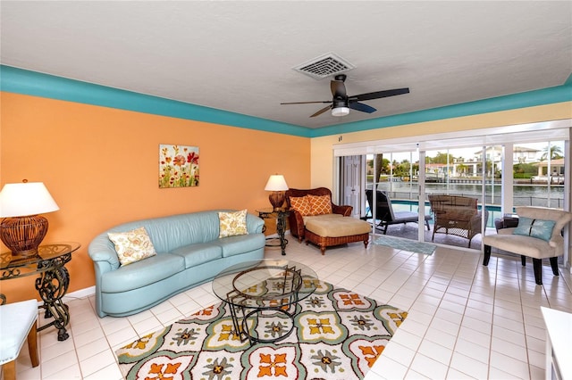 2096 Massachusetts Ave NE, Saint Petersburg, FL 33703 - living area with tile patterned floors, a ceiling fan, and a water view