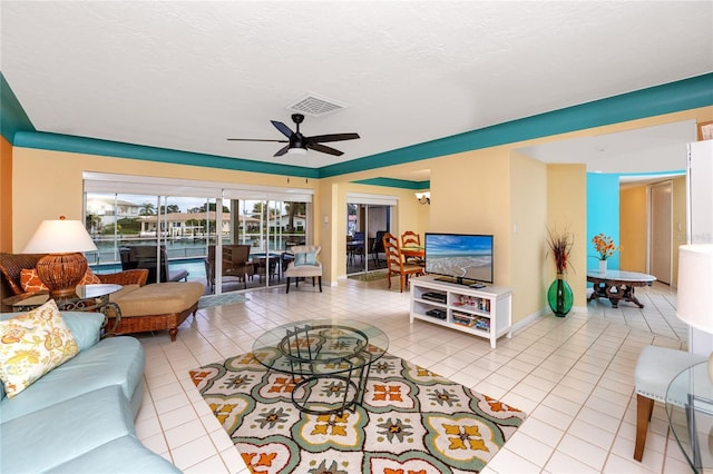 2096 Massachusetts Ave NE, Saint Petersburg, FL 33703 - tiled living room with a ceiling fan