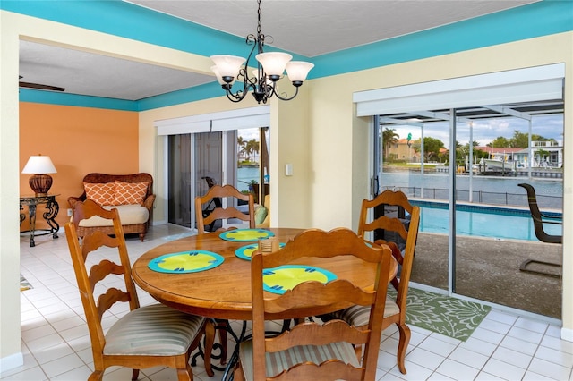 2096 Massachusetts Ave NE, Saint Petersburg, FL 33703 - dining space featuring light tile patterned flooring, plenty of natural light, and a chandelier