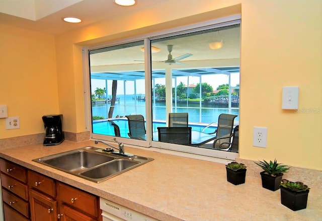 2096 Massachusetts Ave NE, Saint Petersburg, FL 33703 - kitchen with a sink, ceiling fan, light countertops, a water view, and recessed lighting