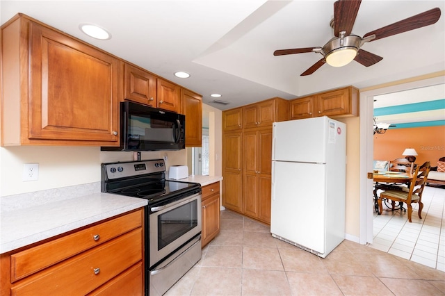 2096 Massachusetts Ave NE, Saint Petersburg, FL 33703 - kitchen with freestanding refrigerator, stainless steel range with electric stovetop, black microwave, recessed lighting, and light countertops