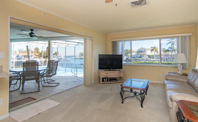 2096 Massachusetts Ave NE, Saint Petersburg, FL 33703 - living area with ceiling fan, carpet floors, ornamental molding, and baseboards