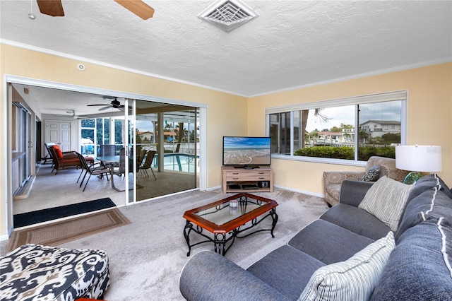 2096 Massachusetts Ave NE, Saint Petersburg, FL 33703 - carpeted living area with a ceiling fan, ornamental molding, a textured ceiling, and baseboards