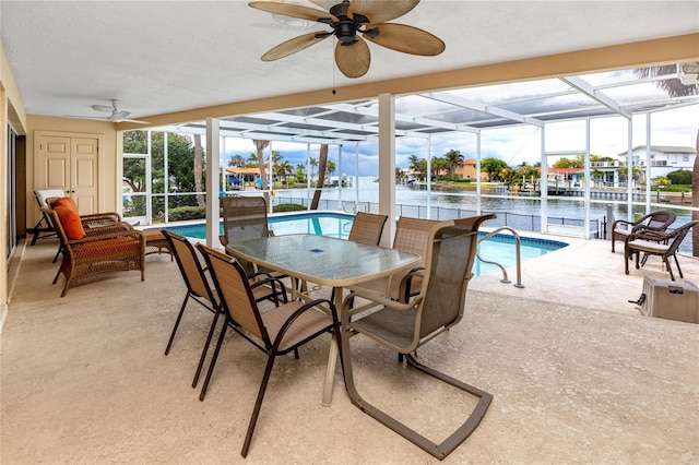 2096 Massachusetts Ave NE, Saint Petersburg, FL 33703 - sunroom / solarium with a swimming pool, a ceiling fan, and a water view