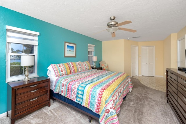 2096 Massachusetts Ave NE, Saint Petersburg, FL 33703 - tiled bedroom with carpet, a textured ceiling, ceiling fan, and baseboards