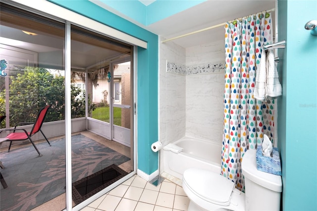 2096 Massachusetts Ave NE, Saint Petersburg, FL 33703 - full bathroom with toilet, shower / bathtub combination with curtain, tile patterned flooring, and baseboards