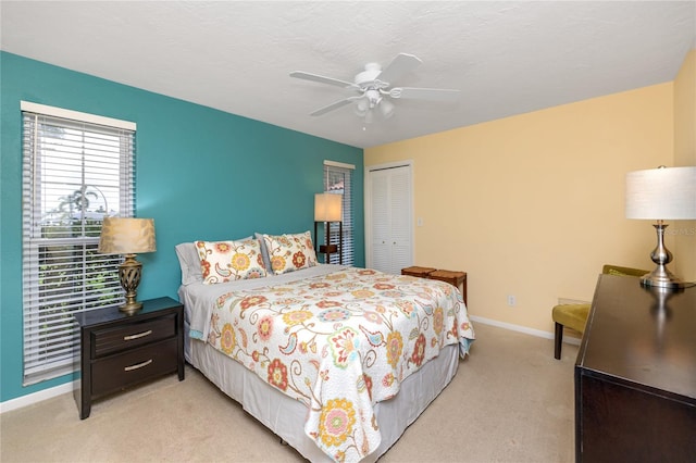 2096 Massachusetts Ave NE, Saint Petersburg, FL 33703 - bedroom with a closet, light colored carpet, baseboards, and ceiling fan