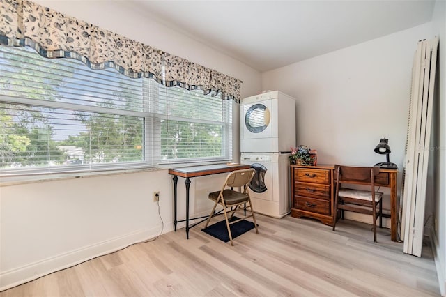 4748 Azalea Dr Unit 204, New Port Richey, FL 34652 - sitting room with stacked washing machine and dryer and light wood-type flooring