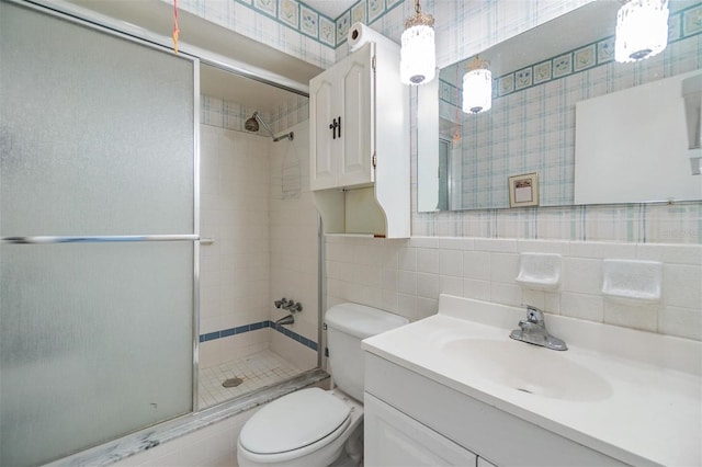4748 Azalea Dr Unit 204, New Port Richey, FL 34652 - bathroom featuring a shower stall, toilet, vanity, and tile walls