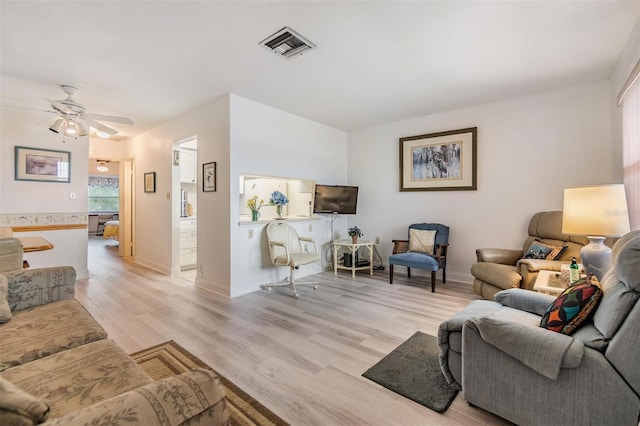 4748 Azalea Dr Unit 204, New Port Richey, FL 34652 - living area featuring light wood-type flooring, a ceiling fan, and baseboards