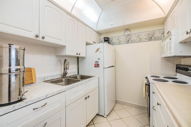 4748 Azalea Dr Unit 204, New Port Richey, FL 34652 - kitchen featuring white appliances, a sink, decorative backsplash, white cabinets, and light tile patterned flooring