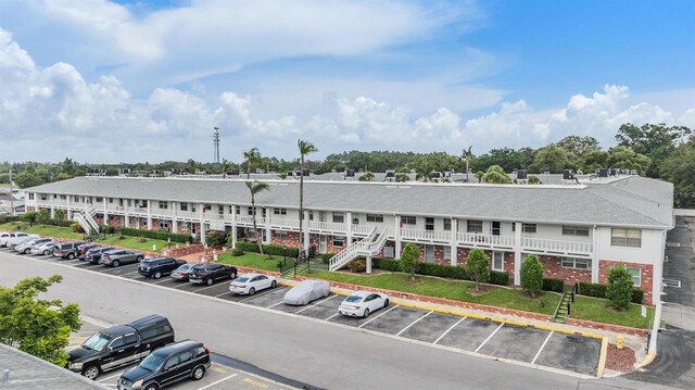 4748 Azalea Dr Unit 204, New Port Richey, FL 34652 - view of property featuring uncovered parking and stairs