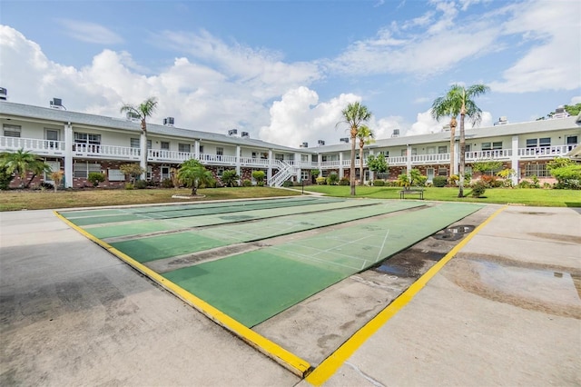 4748 Azalea Dr Unit 204, New Port Richey, FL 34652 - view of home's community with shuffleboard, uncovered parking, and a lawn
